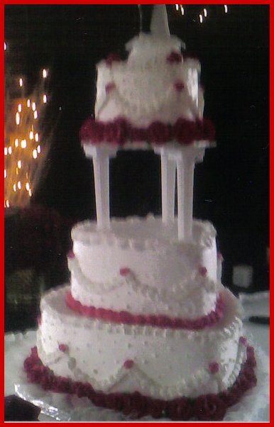 Wedding Cake heart shaped accented with red roses and Dotted Swiss